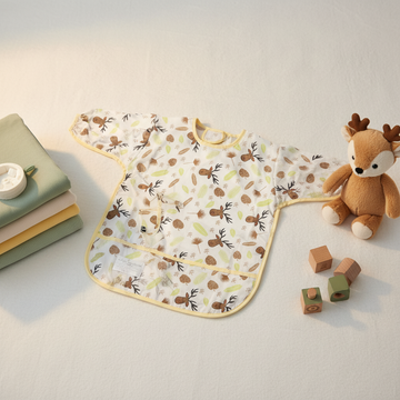 Deer Print Full Sleeve Baby Feeding Bib Smock - lifestyle scene with deer plush toy and wooden blocks