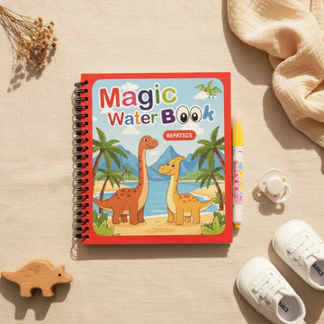 Magic Water Book Dinosaur theme variant showing red spiral-bound book with Brachiosaurus and Pterodactyl cover and yellow water pen on linen background with wooden dinosaur toy and baby shoes