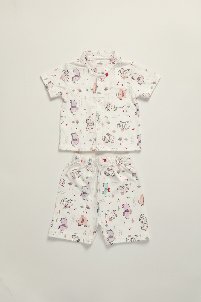 Baby shirt and shorts set neatly arranged on warm white background
