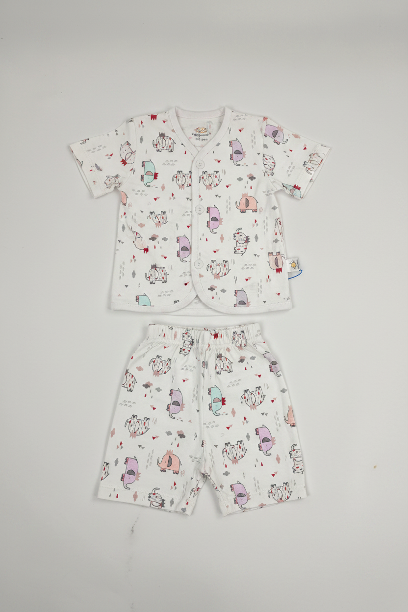 Baby shirt and shorts set with cartoon animal print laid flat on white background