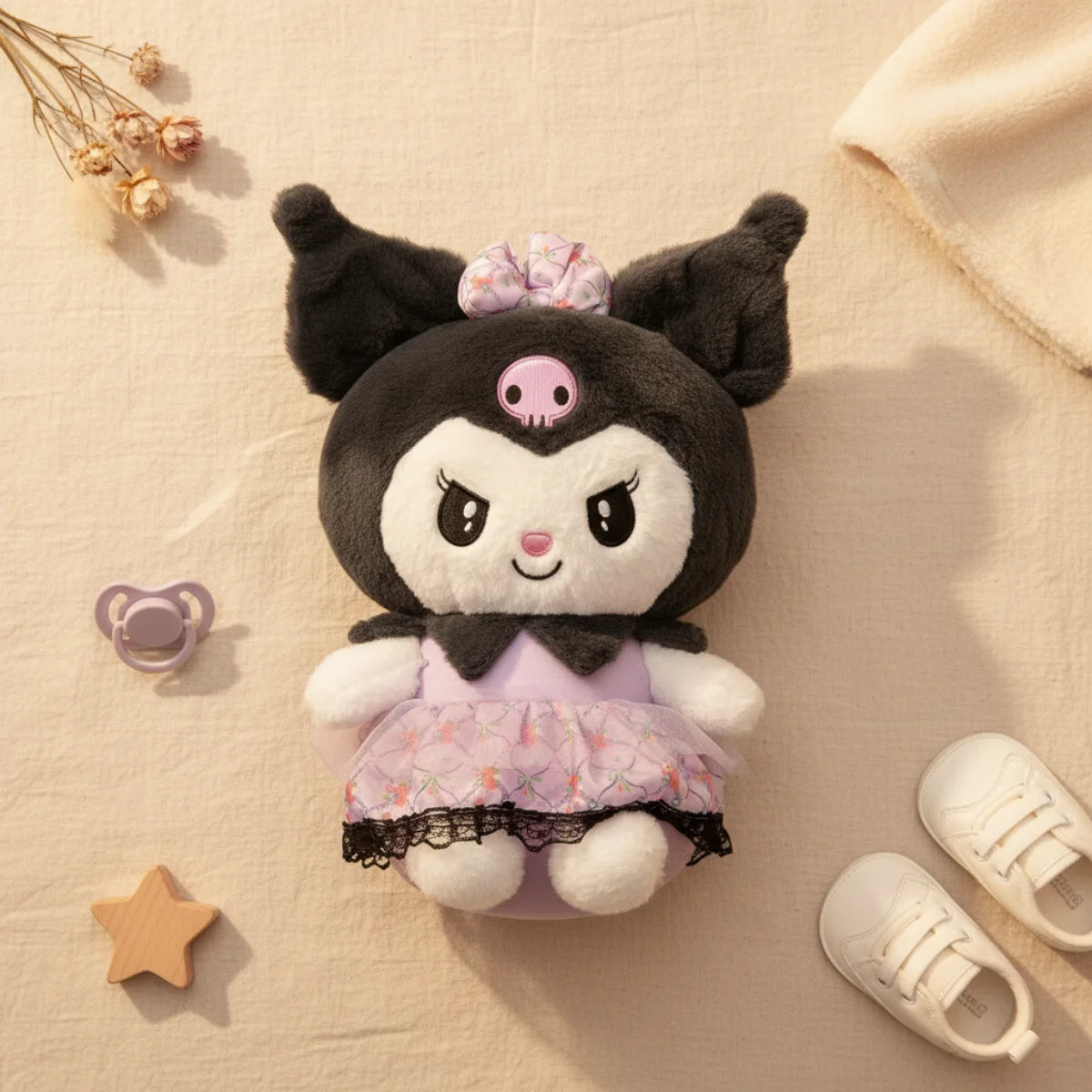 Kuromi plush toy with lavender lace dress flat lay on linen background with purple pacifier wooden star shape white baby sneakers and dried flowers showing full soft black plush body lavender ruffled dress and scrunchie bow from above