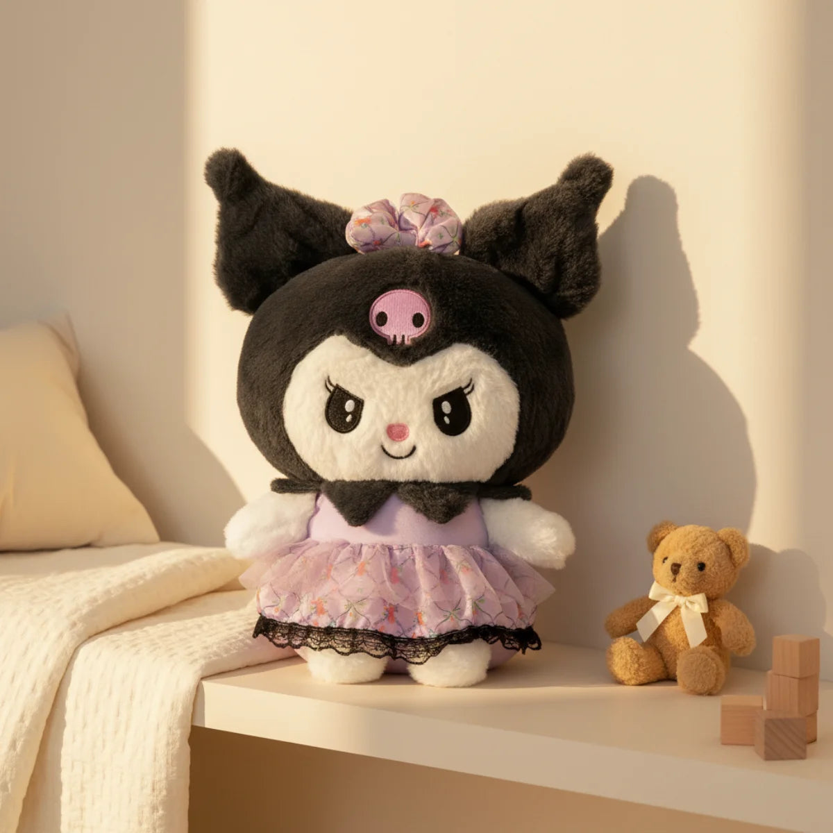 Kuromi plush toy with lavender lace dress displayed on white shelf beside small brown teddy bear with white ribbon in warm cream nursery room setting with wooden blocks and white knit throw blanket