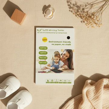 8.5 inch LCD Writing Tablet product box card showing colour tablet features environment friendly no paper no chalk with painting graffiti practice and calculus uses on linen background with wooden block pacifier baby shoes and dried flowers