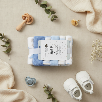 Duck Duck Goose Baby Boy Washcloth Set 12 Pack - lifestyle flat lay with white baby shoes wooden rattle pacifier eucalyptus and dried flowers on linen