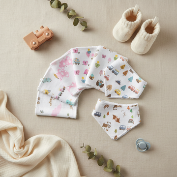 Little Home Baby Girl Washcloth Bandana Bib Set - lifestyle flat lay with wooden train toy baby booties pacifier eucalyptus and cream muslin on linen