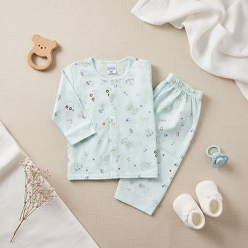 Mamo Light Blue Bear Print Baby Pyjama Set - lifestyle flat lay on beige linen with wooden bear ring teether white baby booties teal pacifier dried pink baby's breath flowers and white muslin cloth