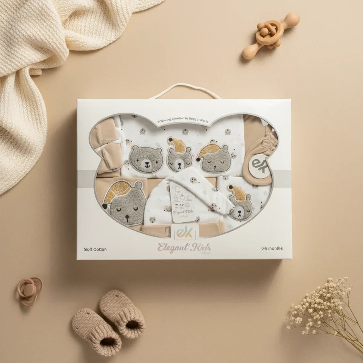 Bear Newborn Gift Set in bear-face gift box on beige background with baby booties wooden rattle pacifier white blanket and dried flowers