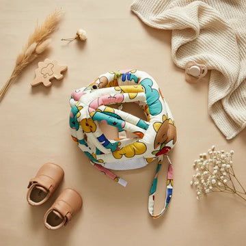 Happy Bears Baby Safety Helmet flat lay with baby shoes pacifier wooden puzzle piece pampas grass and white flowers on beige background