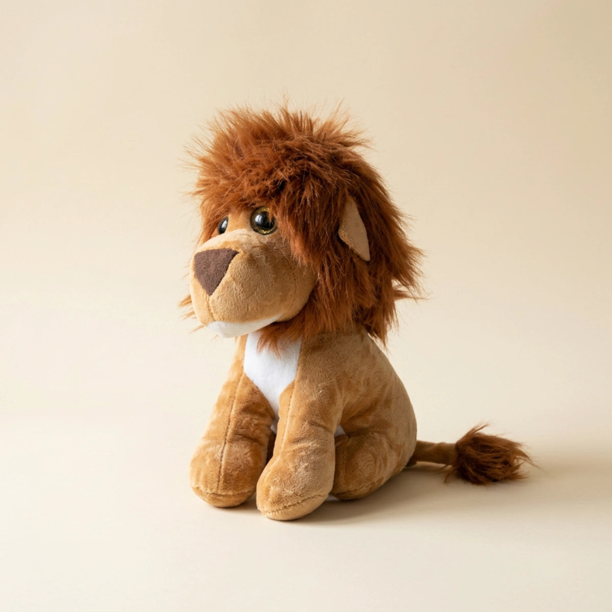 Golden-brown lion plush shown from the side in a warm cream studio
