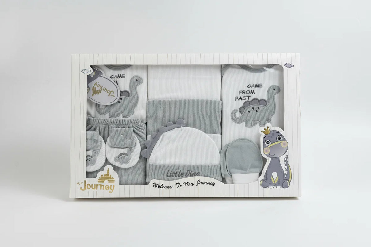 Little Dino Newborn Gift Set in grey in illustrated gift box with clear window showing two dinosaur bodysuits footed trousers Little Dino hat mittens and booties on white background