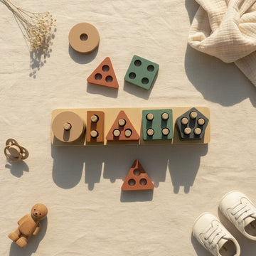 Montessori geometric shape sorter stacker flat lay showing wooden board with all 5 shape stacks circle triangle square and pentagon with loose terracotta triangle and sage green square pieces on linen background with pacifier wooden bear figurine white sneakers and dried flowers