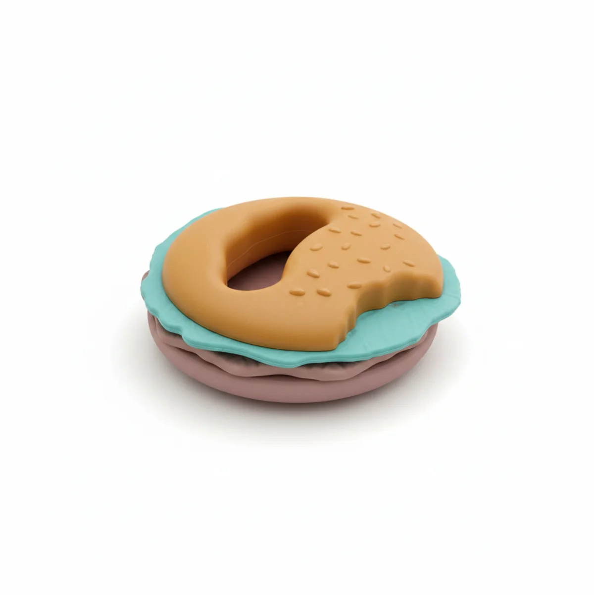 Burger silicone baby teether hero white background showing full three layer design golden textured sesame bun with ring handle teal scalloped lettuce layer and dusty mauve pink bun base on clean white background