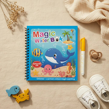 Magic Water Book Ocean theme blue cover showing smiling whale tropical fish octopus seahorse and starfish underwater scene with yellow water pen on linen background with wooden fish and crab toys