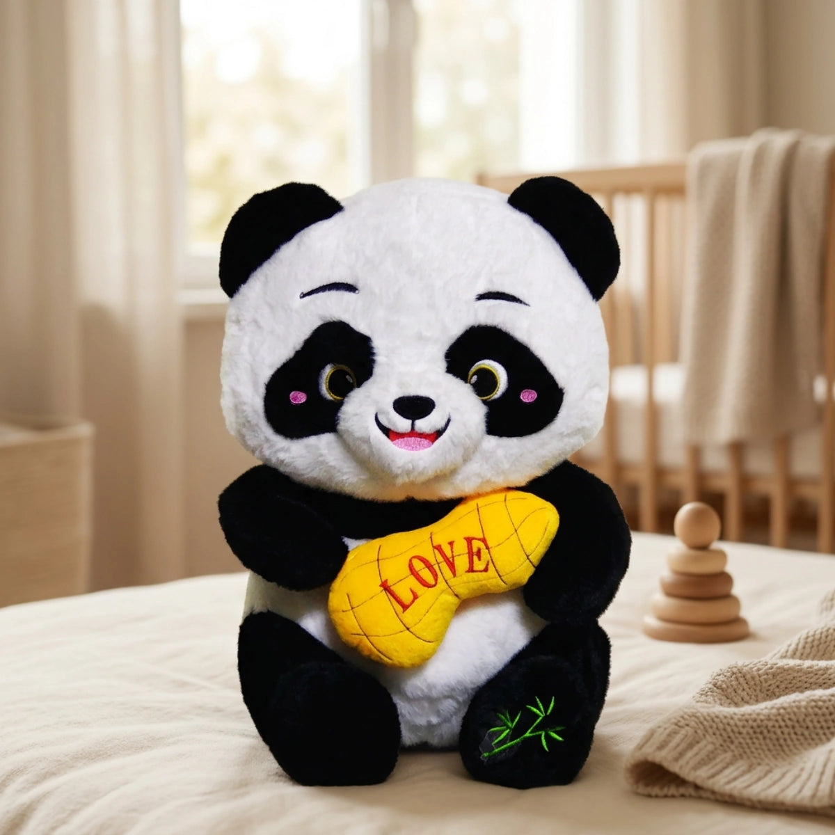 Black-and-white panda plush holding a yellow LOVE cushion in a nursery