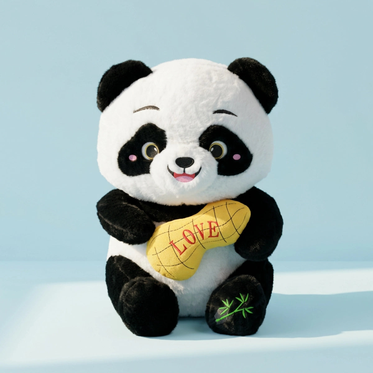 Panda plush with yellow LOVE cushion against a pale blue background