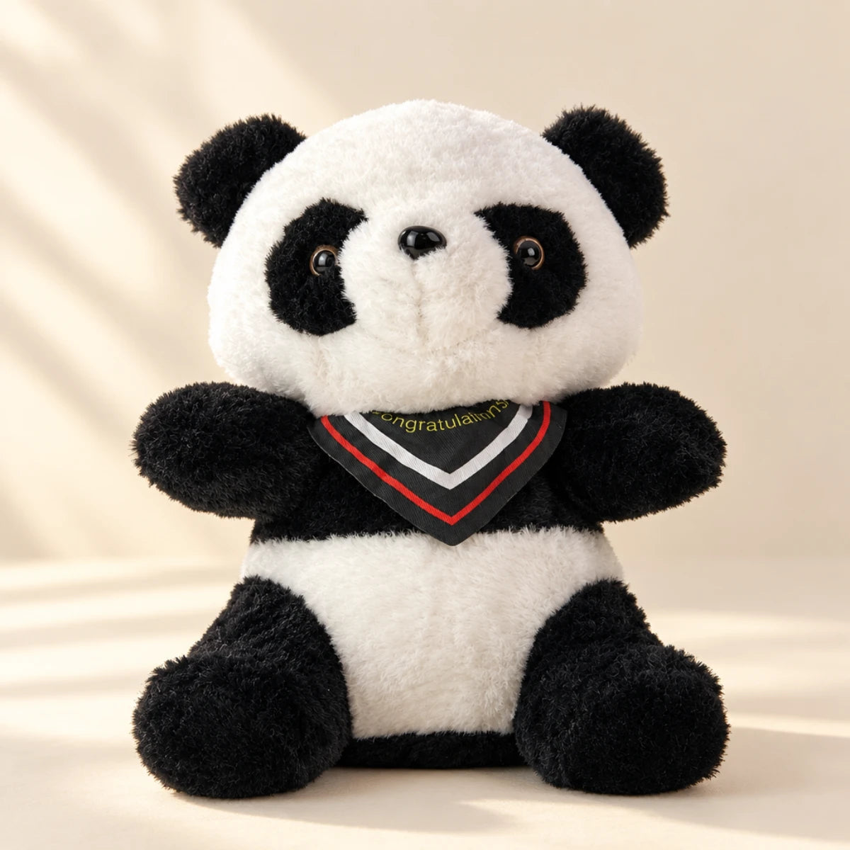 Panda plush toy in a softly lit neutral studio setting