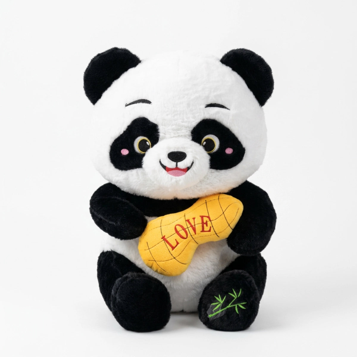 Smiling black-and-white panda plush holding a yellow LOVE cushion