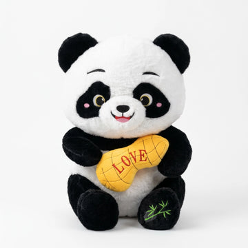 Smiling black-and-white panda plush holding a yellow LOVE cushion