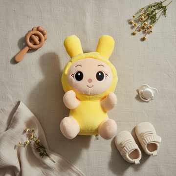 Yellow bunny girl plush doll – premium flat lay on linen with wooden rattle, baby shoes, pacifier and chamomile flowers