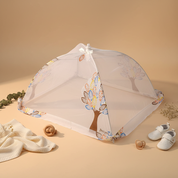 Foldable baby crib mosquito net – premium flat lay lifestyle scene on cream background with baby shoes, pacifier, wooden rattle and eucalyptus showing open net from front angle