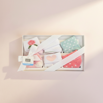 Hudson Baby Girl Socks Gift Box Set 4 Pair - premium studio scene top view open gift box with satin ribbon bow on blush pink background