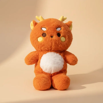 Ember the Orange Dragon plush toy – studio shot on warm beige background
