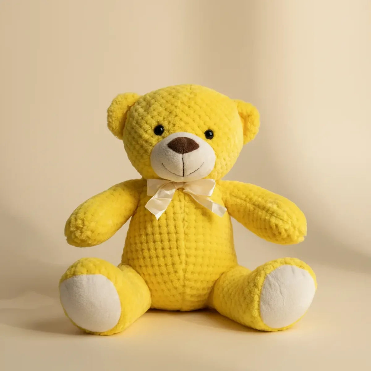 Sunny the Yellow Waffle Teddy Bear studio shot on warm beige background