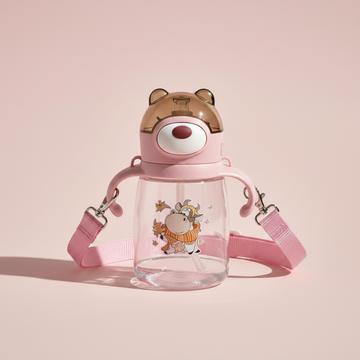 Pink bear ear kids water bottle – premium studio scene on pink background showing full bottle with bear lid, dual handles and shoulder strap