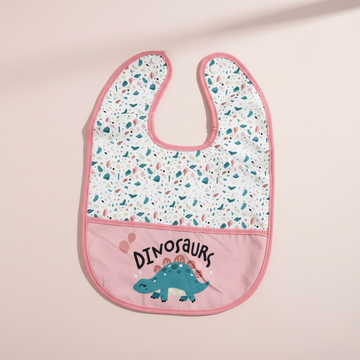 Pink dinosaurs waterproof baby bib – premium studio flat lay on pink background showing full terrazzo print top and pink dinosaur pocket