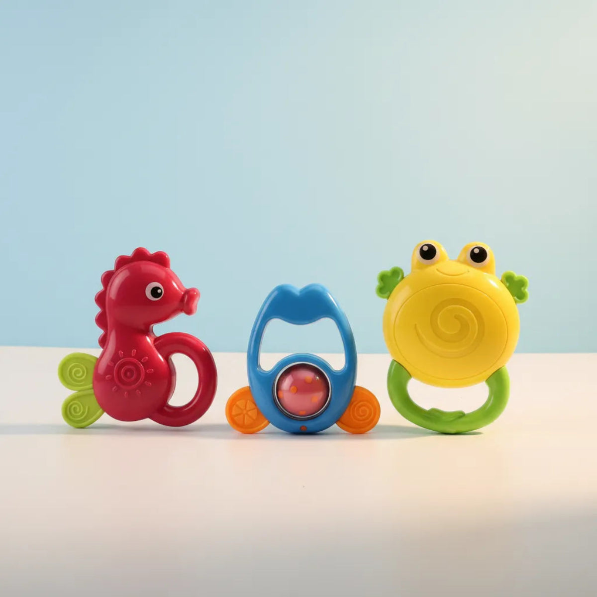 Ocean Friends Baby Rattle Set studio shot of three rattles standing upright on light blue background