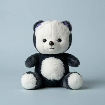 Pebble the Panda Bear plush toy studio shot on soft blue background