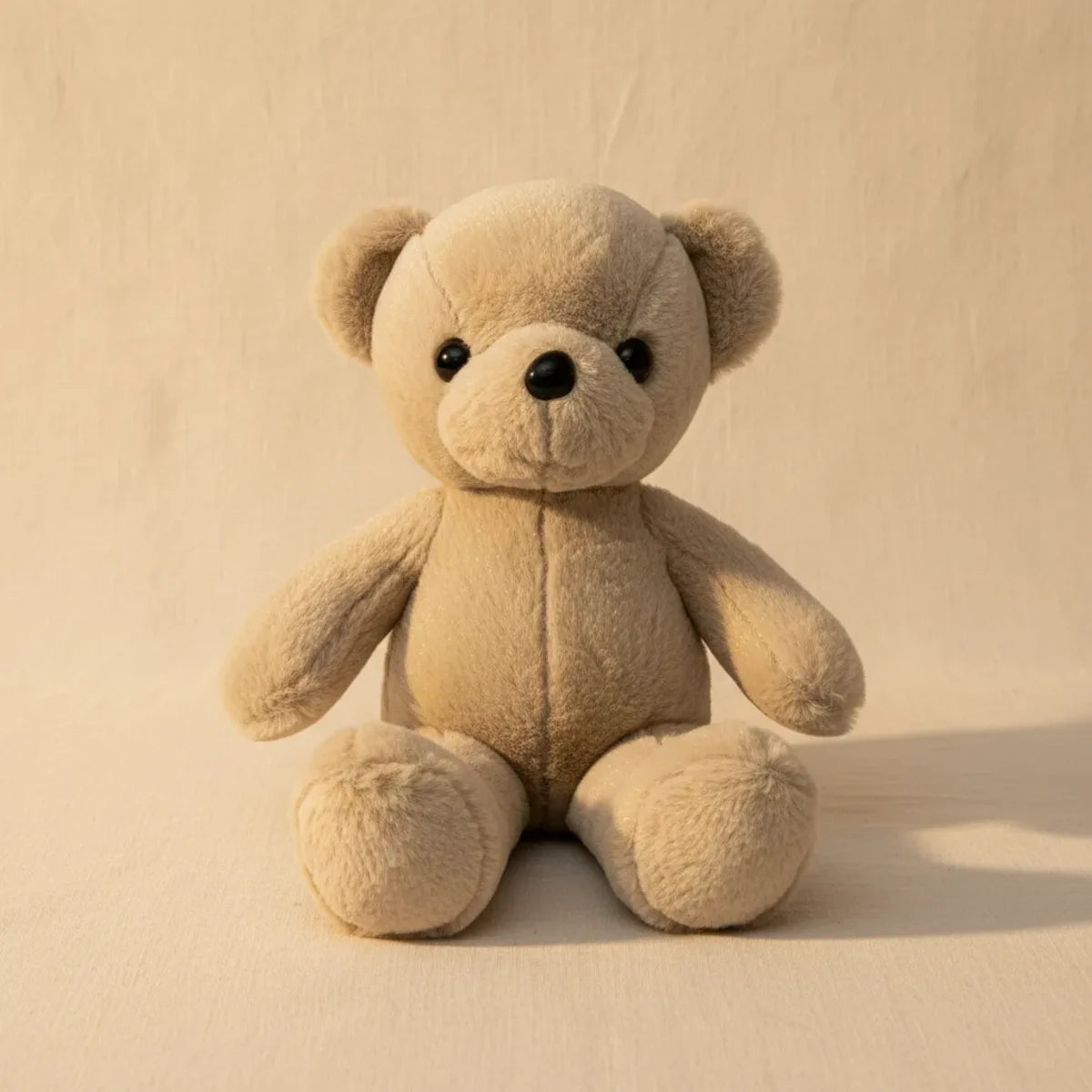 Sandy the Beige Minimalist Teddy Bear studio shot on warm cream background
