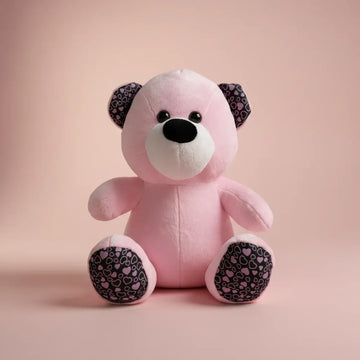 Rosie the Pink Heart Teddy Bear studio shot on blush pink background showing heart-print ears and paw pads