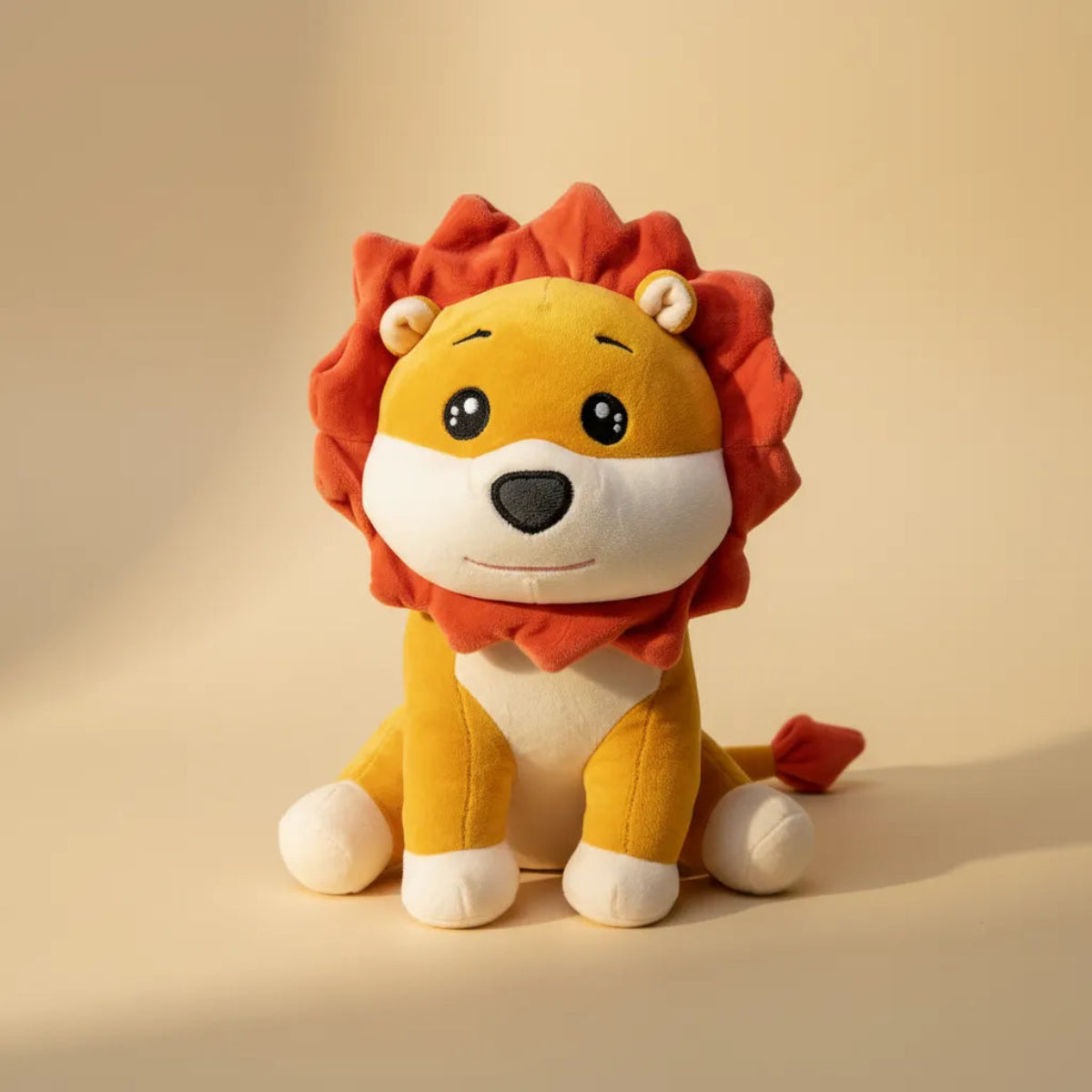 Roary the Cartoon Lion Cub plush toy studio shot on warm cream background showing golden body and rust-red mane