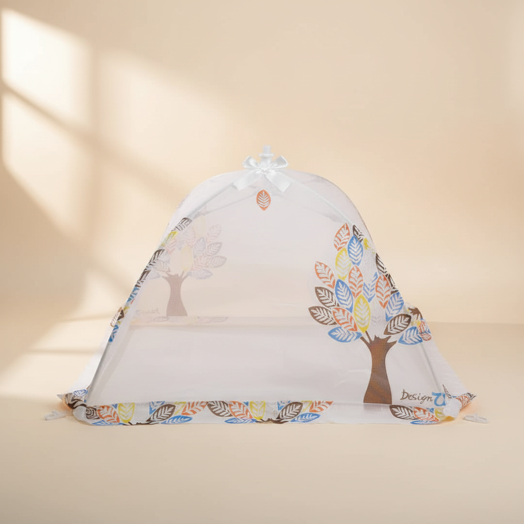 Foldable baby crib mosquito net – premium studio scene on warm beige background showing dome net open with colorful tree print and satin bow detail
