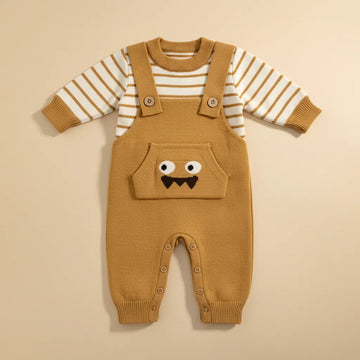 Little Monster Knit Dungaree Set flat lay showing caramel stripe sweater and monster face dungarees with snap buttons on beige background