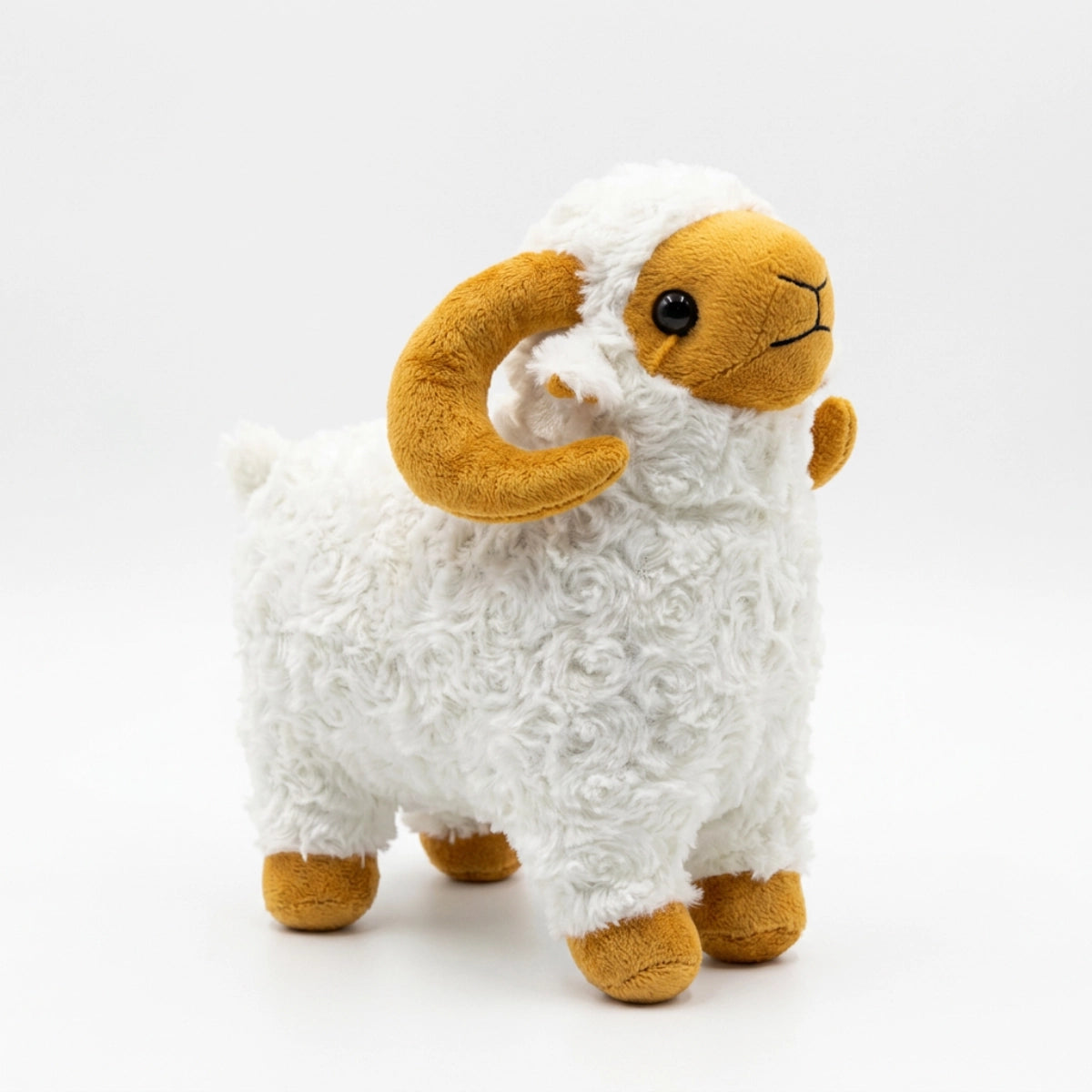 White ram plush with golden-brown curled horns and feet on a white background